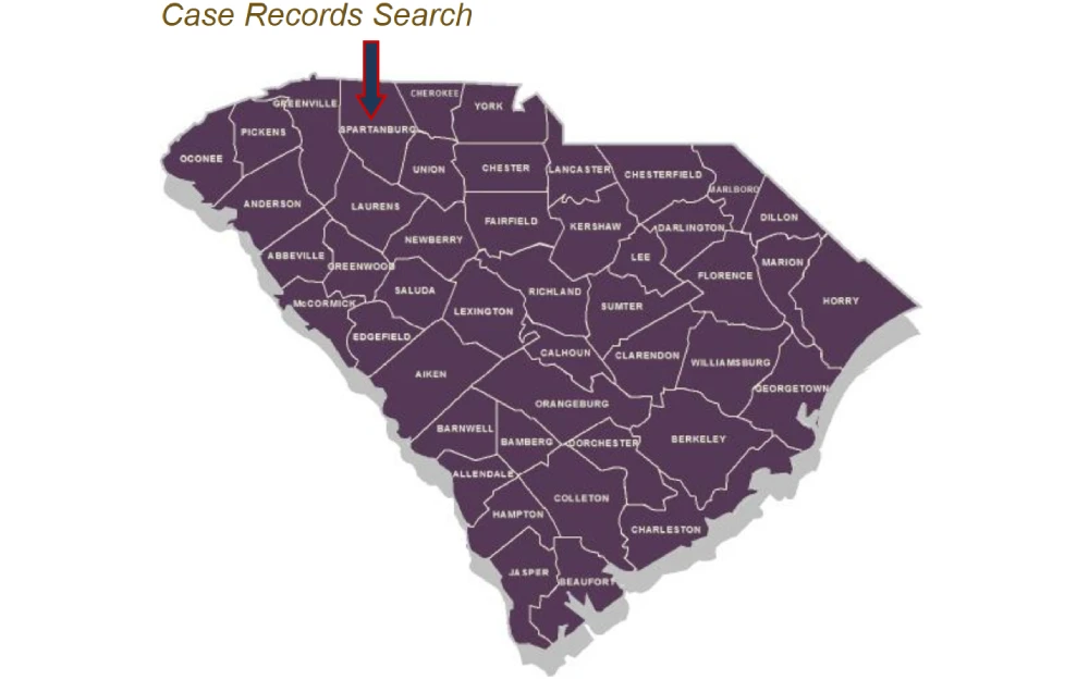 An interactive map of South Carolina highlighting its counties, with an indicator pointing to Spartanburg County used for navigating to local case records via an online search portal.